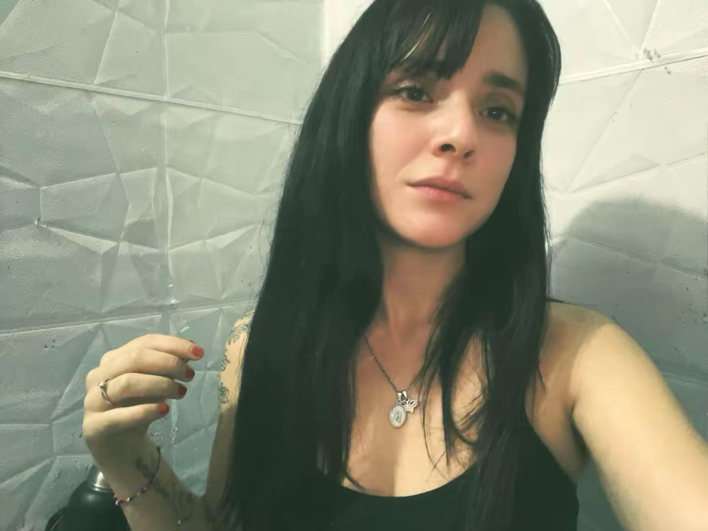 A woman from Uruguay with dark bangs looking into the camera