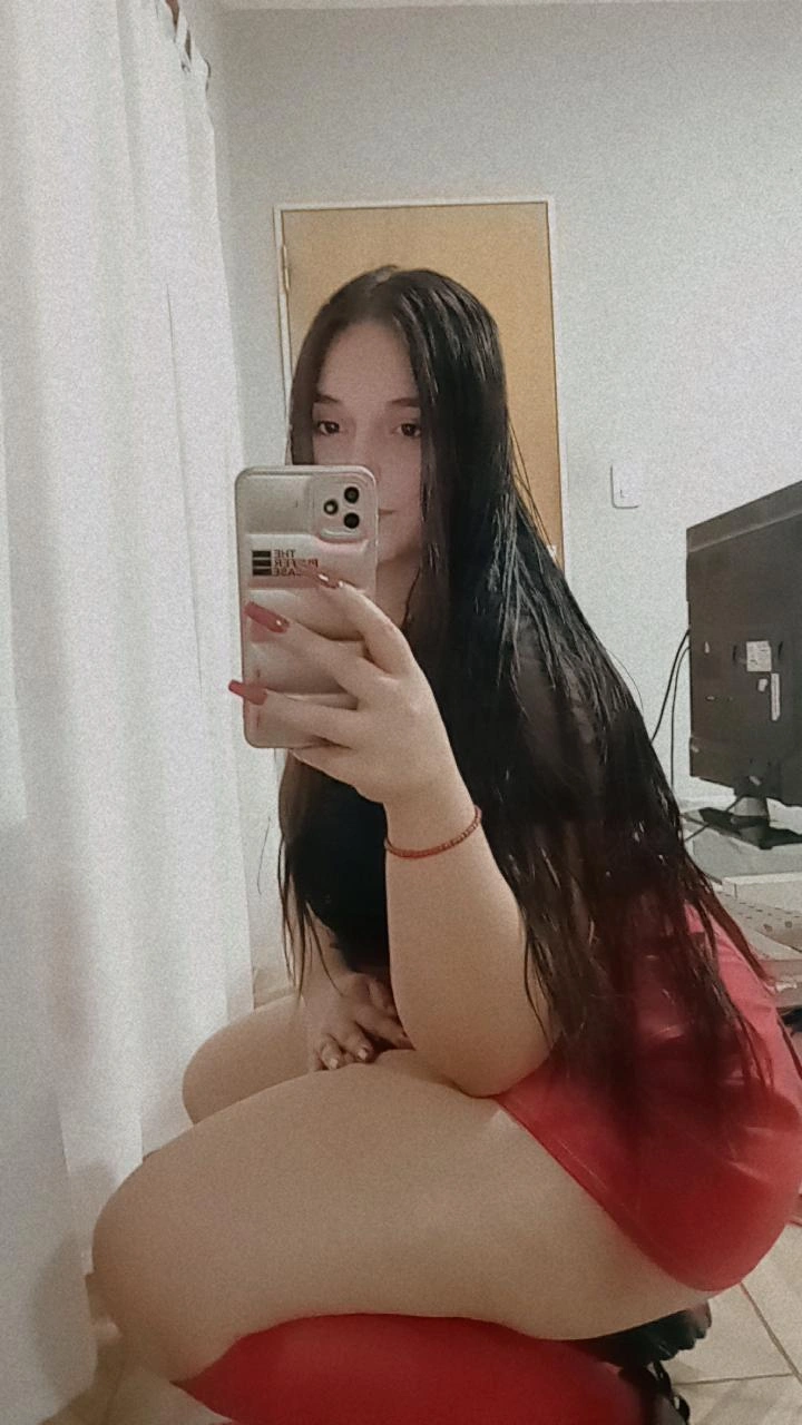 A woman from Argentina holding her phone camera up for a cam to cam chat